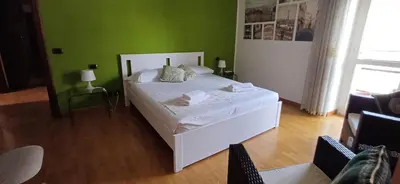 a bedroom with a white bed and green walls at Lively House in Rome