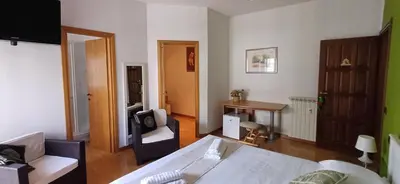 a living room with a bed and a table at Lively House in Rome
