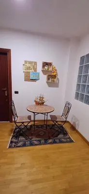 a table in a room with two chairs and a table at Lively House in Rome
