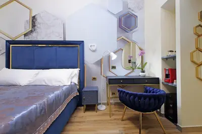 a bedroom with a bed and a desk and a chair at Just Chilling Ferruccio in Rome