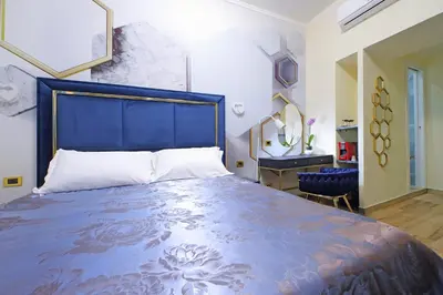 a bedroom with a large bed with a blue headboard at Just Chilling Ferruccio in Rome