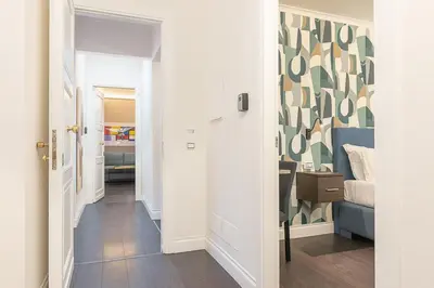 a hallway with a door leading to a bedroom at Maison dei Greci in Rome