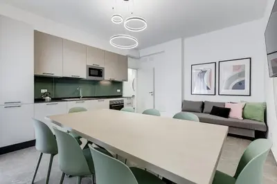 a kitchen and living room with a table and chairs at BDC - Mariposa 3BDR in San Giovanni in Rome