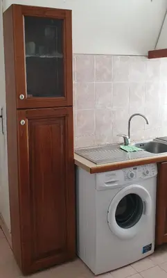 a kitchen with a washing machine and a sink at Camera con vista MetroA in Rome