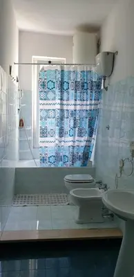 a bathroom with two toilets and a shower and a sink at Camera con vista MetroA in Rome