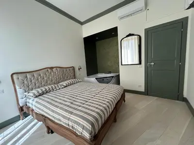 a bedroom with a bed with a sink and a mirror at Home Domus Castel Sant'Angelo in Rome