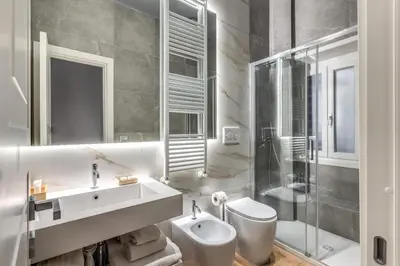 a bathroom with a sink and a toilet and a shower at Maison Carrozze in Rome