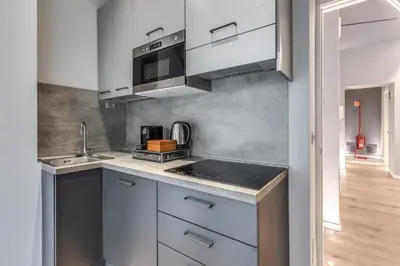 a small kitchen with a sink and a microwave at Maison Carrozze in Rome