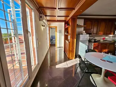 a kitchen with a table and chairs and a window at Rooftop Marconi in Rome