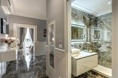 a bathroom with a shower and a sink and a mirror at Spanish Steps Oasis Suite in Rome