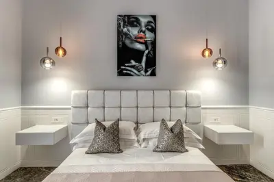 a bedroom with a king sized bed with two night stands at Spanish Steps Oasis Suite in Rome