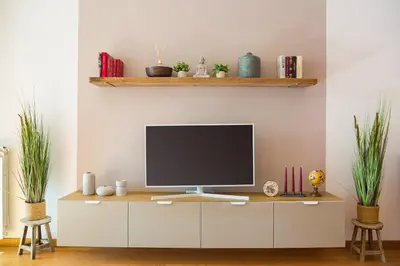 a television sitting on a cabinet in a living room at Boutique Domus Trastevere Family in Rome