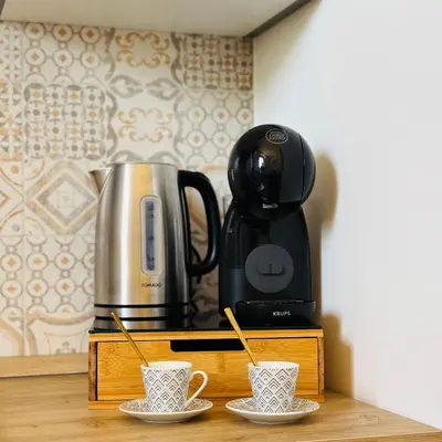 a coffee maker and two cups on a counter at Casa Campani 56 in Rome