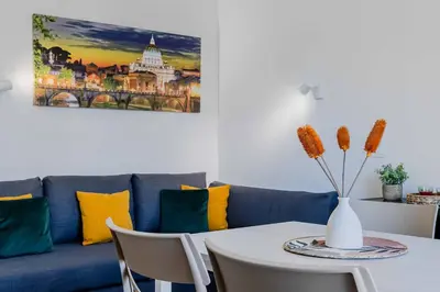 a living room with a blue couch and a table at Your dream in Rome San Paolo in Rome