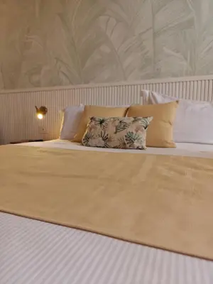 a large bed with pillows on top of it at GG Vatican Townhouse in Rome