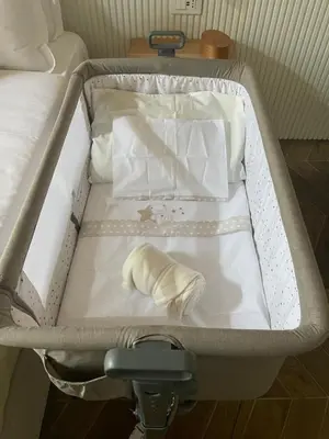 an open suitcase with a bed and a towel at GG Vatican Townhouse in Rome