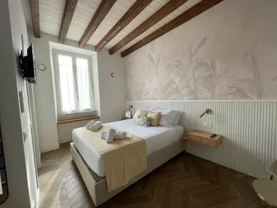 a bedroom with a bed and a television in it at GG Vatican Townhouse in Rome