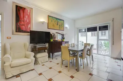 a living room with a table and chairs and a television at Casa Marino Roma in Rome