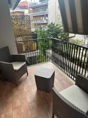 a balcony with chairs and tables and a railing at Star Suite Rome in Rome