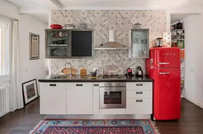 a kitchen with a red refrigerator and white cabinets at Dreamy Loft by the Opera Theater in Rome