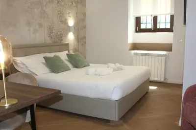 a bedroom with a bed with towels on it at Domus San Pietro - Elegant stay in Vatican in Rome