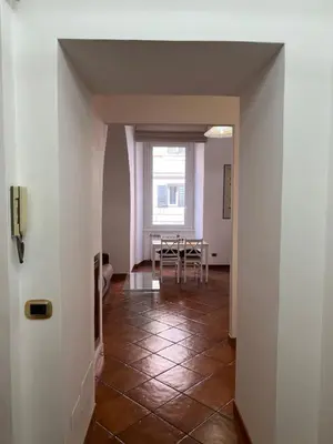 a dining room with a table and a window at Paolina lovely apartment in Rome