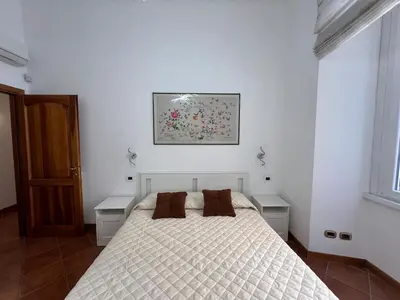 a bedroom with a white bed with two night stands at Paolina lovely apartment in Rome