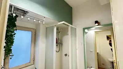 a bathroom with a shower and a large mirror at Tiny Elephant Mini suite in Rome in Rome
