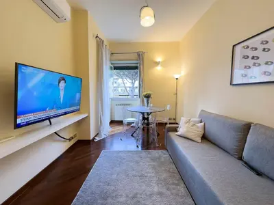 a living room with a couch and a flat screen tv at Casa Anna Vaticano in Rome