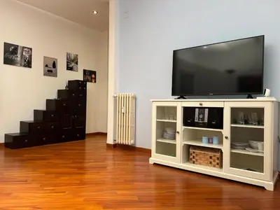 a television on a white entertainment center in a living room at Cris House Monteverde in Rome