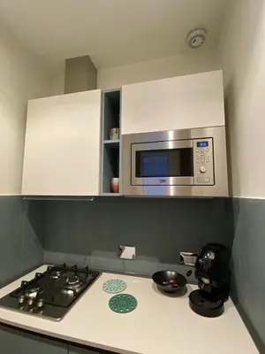 a kitchen with a stove and a microwave at Casa Cherie in Rome