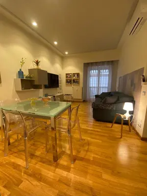 a living room with a black couch and a table at Casa Cherie in Rome