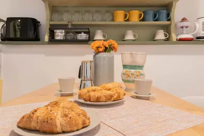 a table with two plates of bread and croissants at Fienaroli in Trastevere in Rome