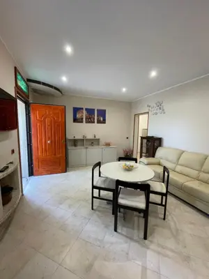 a living room with a table and a couch at Eternal Lemon Home in Rome