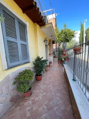 a patio with potted plants on the side of a building at Eternal Lemon Home in Rome