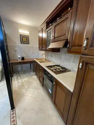 a kitchen with wooden cabinets and a stove top oven at Eternal Lemon Home in Rome