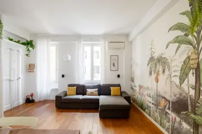 a living room with a couch and a painting on the wall at Botanical Home close Vatican in Rome