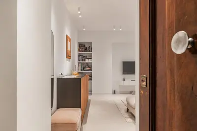 a living room with a couch and a table at GuestHost - Pannonia Colosseum in Rome