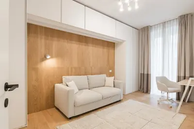 a living room with a white couch and a table at GuestHost - Pannonia Colosseum in Rome