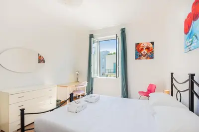 a bedroom with a bed and a dresser and a mirror at Jenner Apartment by Rental in Rome in Rome