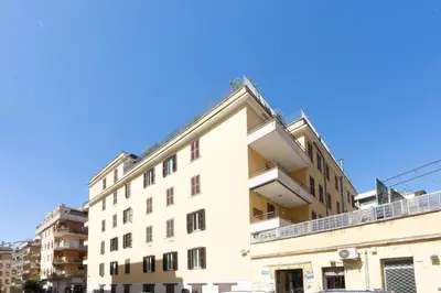 an apartment building with a blue sky in the background at Jenner Apartment by Rental in Rome in Rome