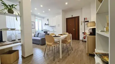 a kitchen and living room with a table and chairs at LoveRhome Apartment 14 in Rome
