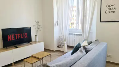 a living room with a blue couch and a tv at LoveRhome Apartment 14 in Rome