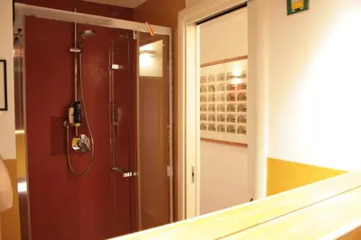 a bathroom with a shower and a mirror at Baccina cozy apartment in Rome