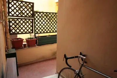 a bike parked next to a building with a window at Baccina cozy apartment in Rome