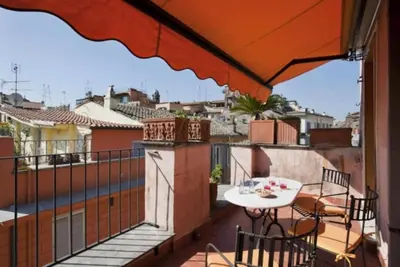 a balcony with a table and a view of a city at Laurina F3 terrace for family - LOCAPPART in Rome