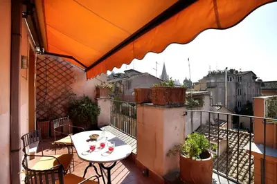 a patio with a table and chairs on a balcony at Laurina F3 terrace for family - LOCAPPART in Rome