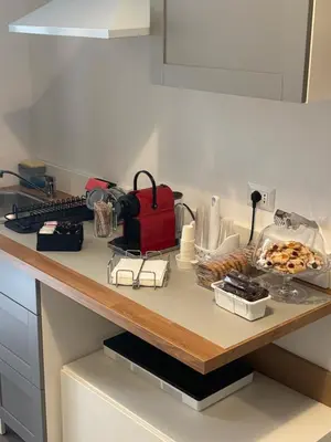 a kitchen counter with a table with food on it at PORTA FURBA Suites in Rome