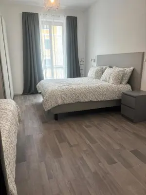 a bedroom with a bed and a wooden floor at PORTA FURBA Suites in Rome