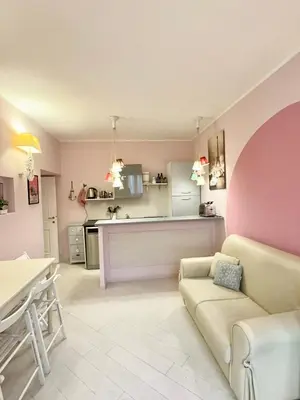 a living room with a couch and a kitchen at Vacanze Romane a San Giovanni in Rome